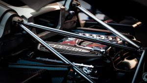 Detailed view of a Pagani hypercar engine showcasing intricate design elements.